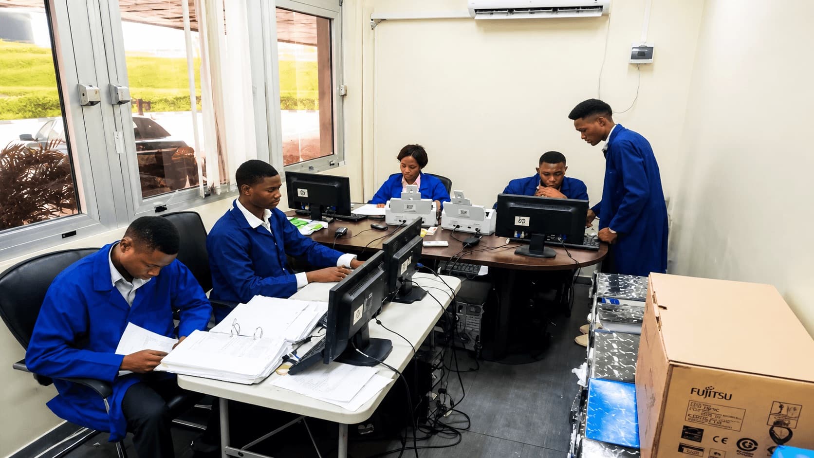 Tecres digitization team operating high-speed scanners